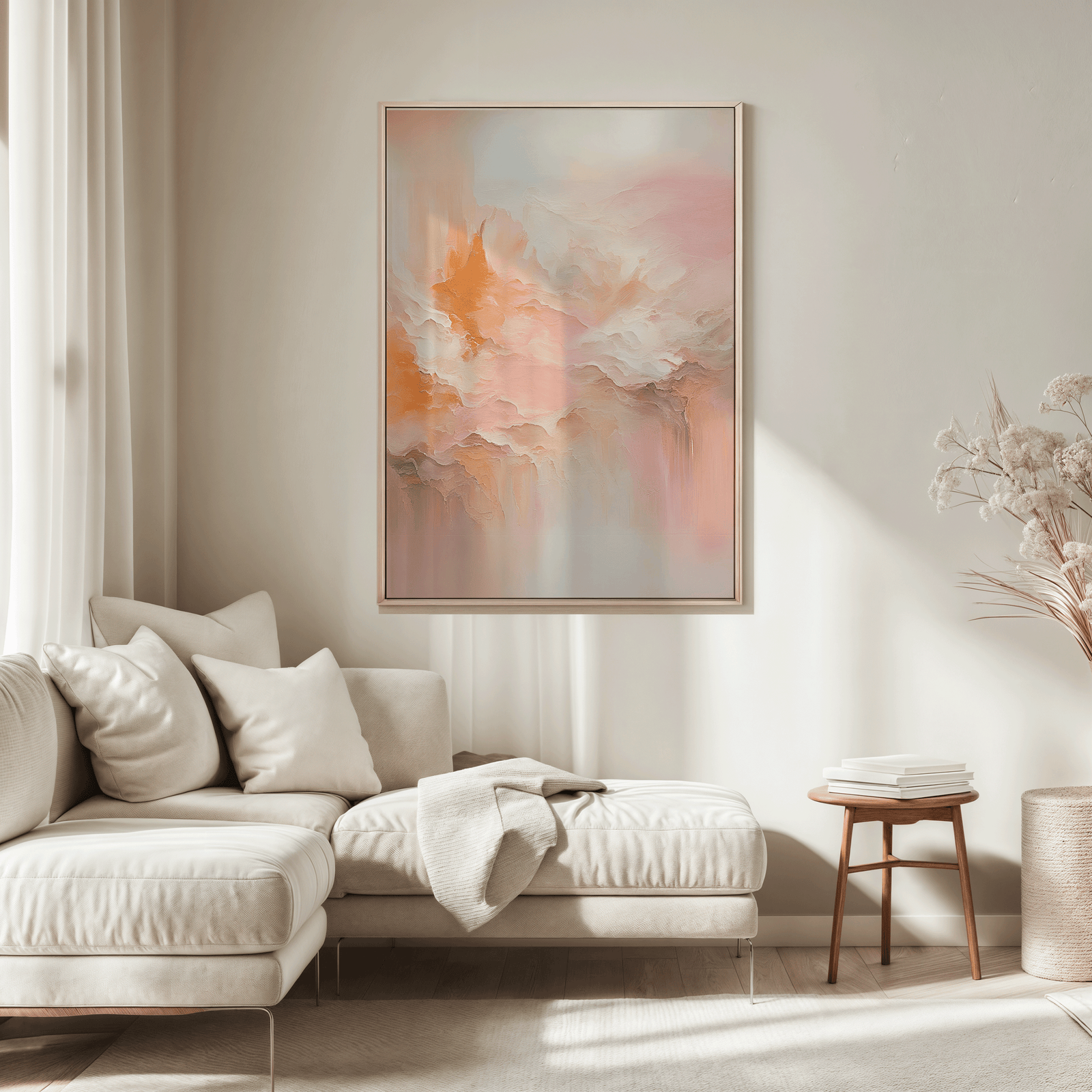 Large blush pink and peach abstract wall art framed in wood above sectional sofa in  neutral living room