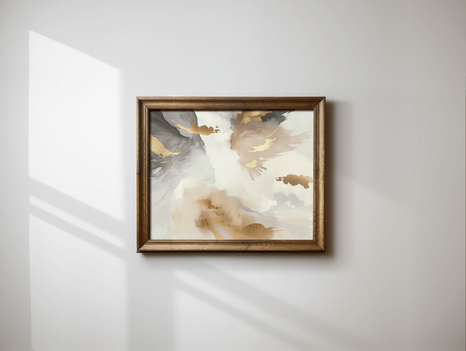 A modern abstract print with a wooden frame on a light grey wall. The wall art has a beautiful mix of blush pink tones, white, cream, beige, grey and gold accents.