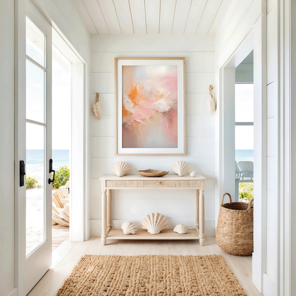 Blush pink and gold abstract wall art in light wood frame styled in coastal entryway with console