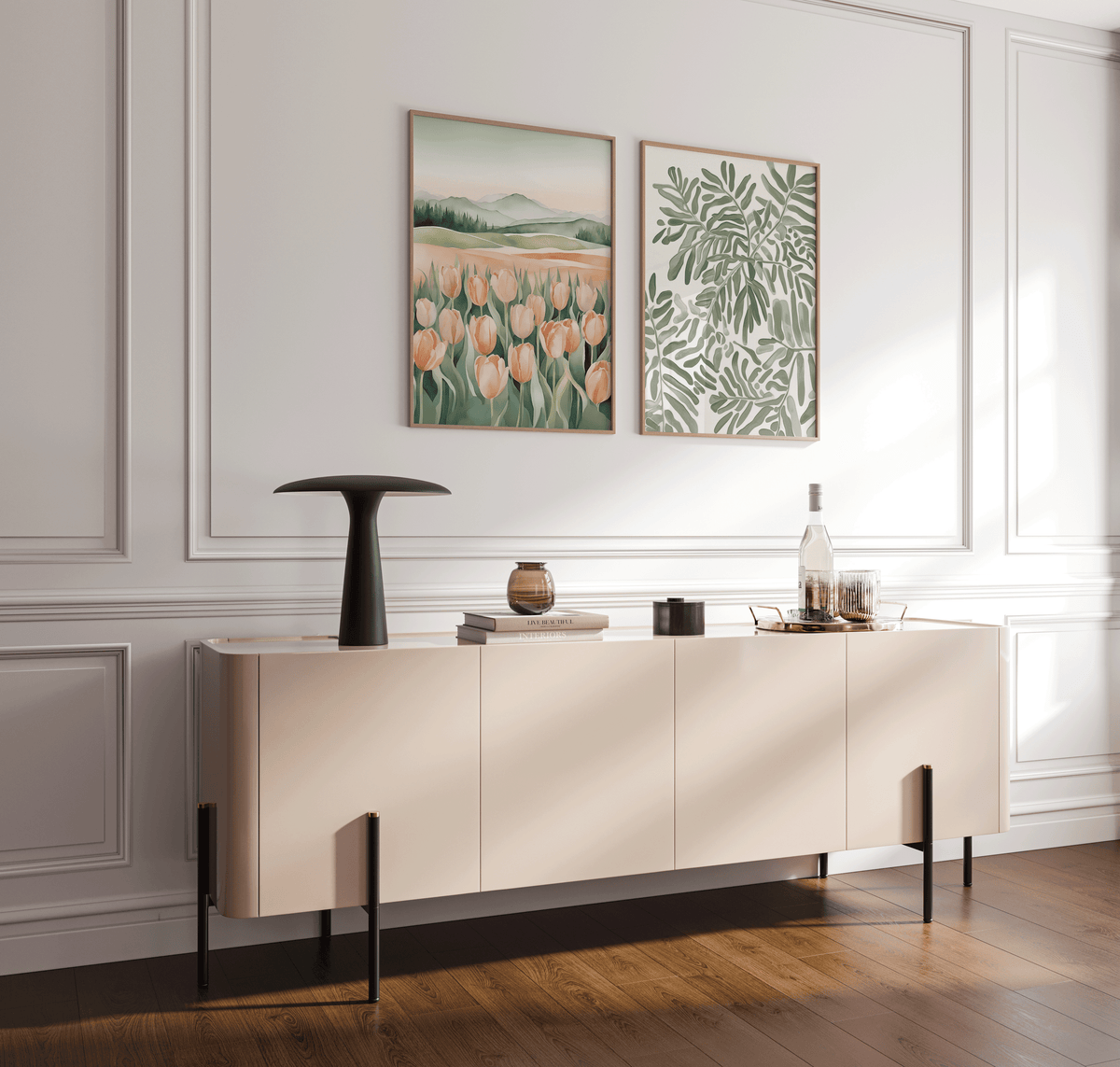 Set of two dining room wall art prints including a botanical leaf design and a soft tulip landscape, displayed side by side in light wood frames above a neutral console table
