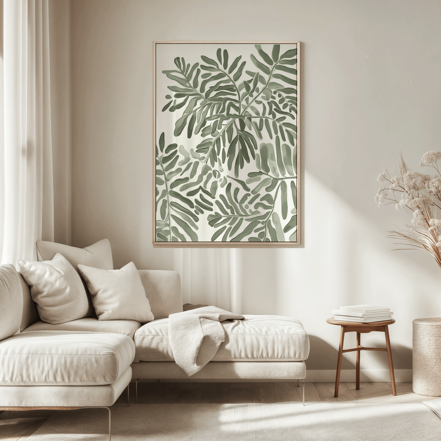 Single botanical leaf wall art print in a light wood frame styled above a cream sectional sofa, featuring soft green foliage artwork in a neutral living room setting