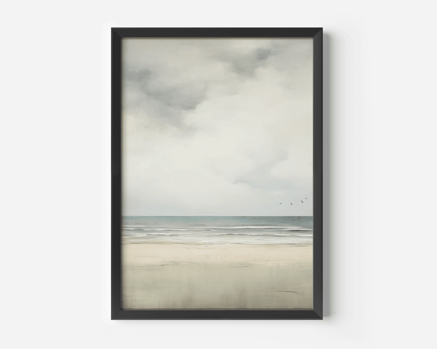 Framed neutral ocean and sky landscape wall art with a black frame on a white wall