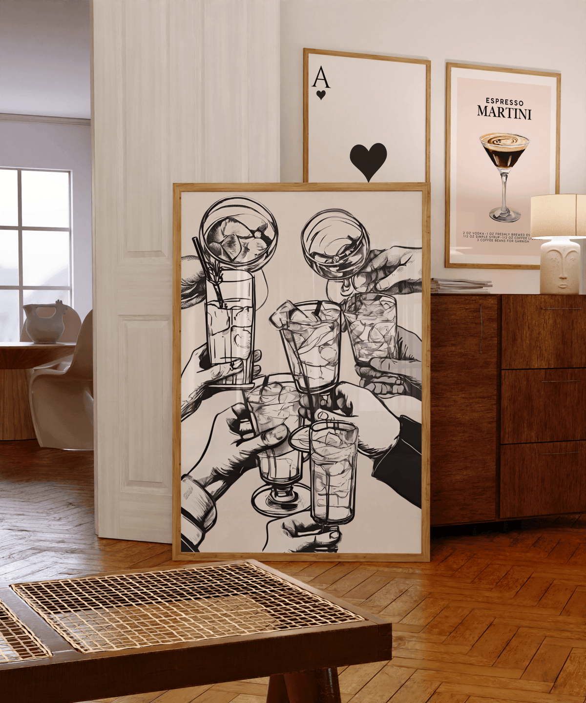 Cheers bar cart art in a gallery wall on a wooden sideboard beside an espresso martini print