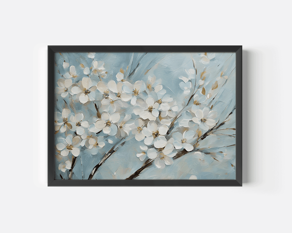 Close-up of cherry blossom wall art showing white flowers on soft blue background in a modern black frame.