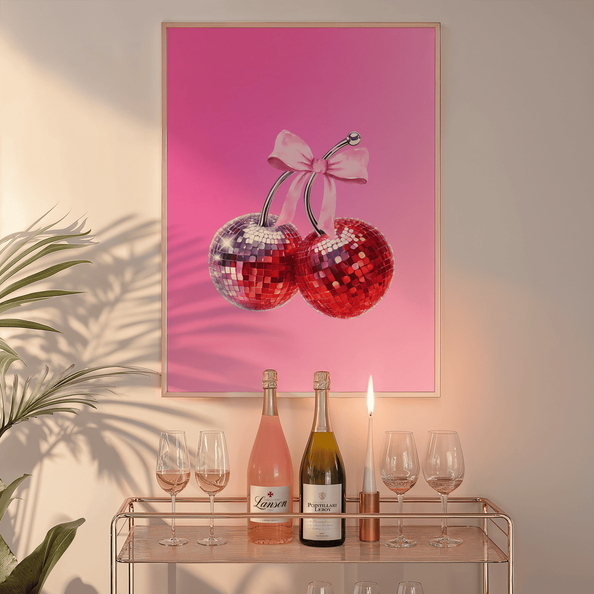 Cherry disco ball print in a natural frame above a glass bar cart with wine bottles and a candle