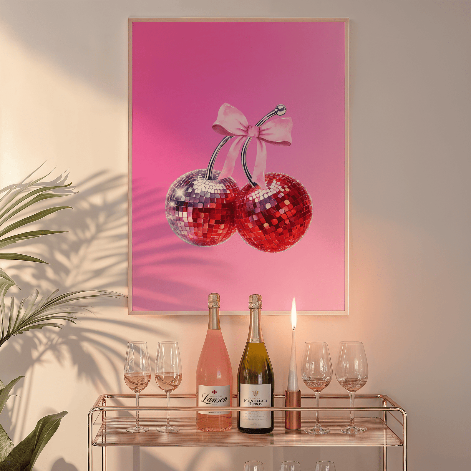 Cherry disco ball print in a natural frame above a glass bar cart with wine bottles and a candle