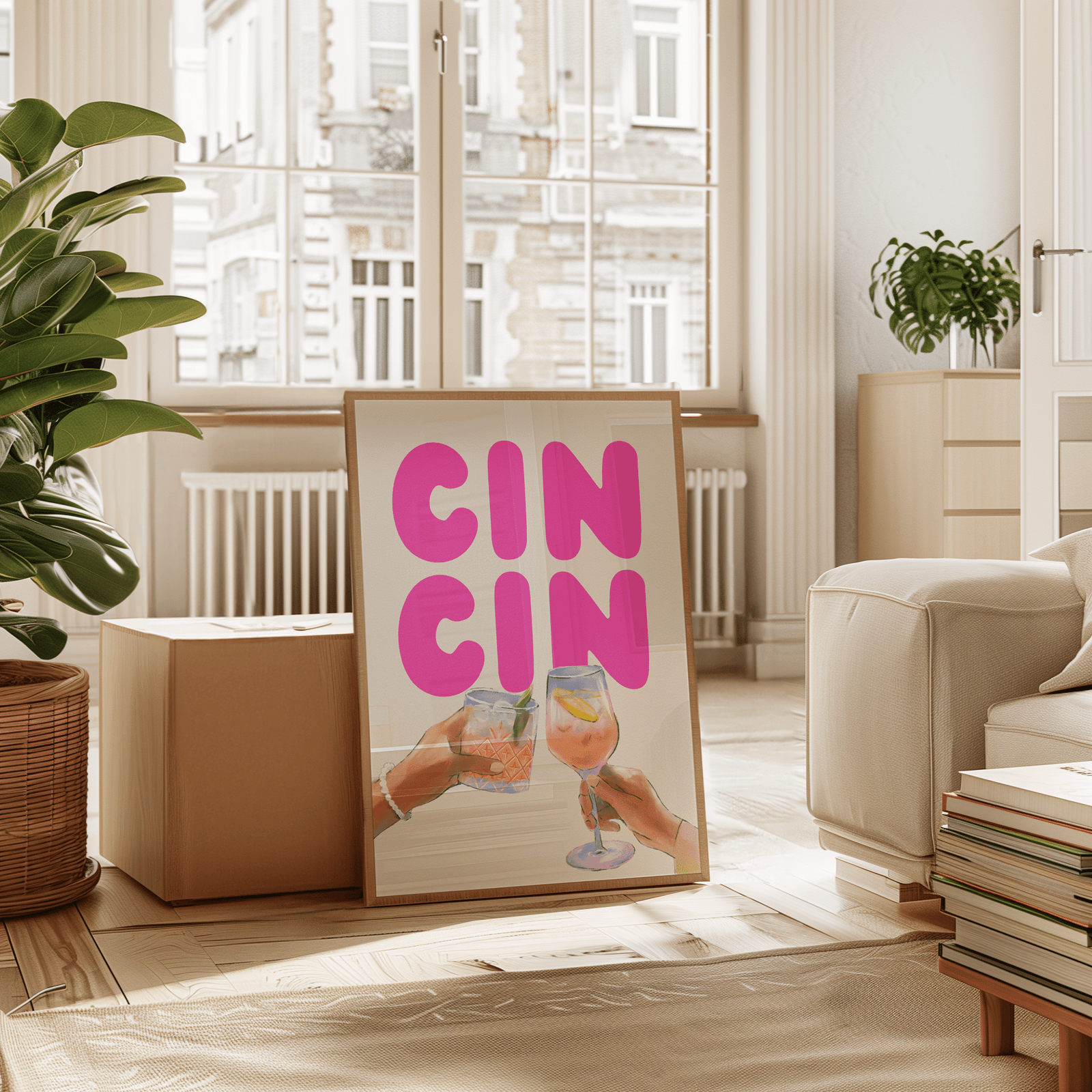 Cin cin wall art in a natural frame leaning in a sunny living room with plants and a cream armchair