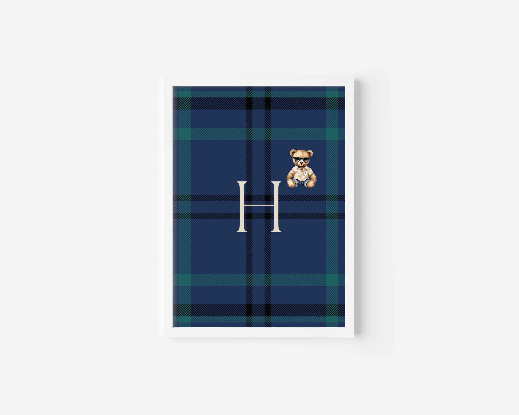 Personalized navy and hunter green plaid monogram wall art with teddy bear in sleek white frame, classic baby boy nursery decor in clean modern room, preppy Ralph Lauren baby style interior inspiration