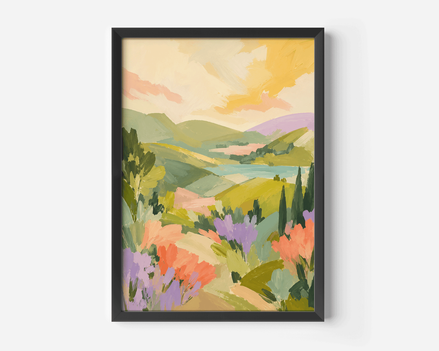 A framed landscape wall art print with a colorful painted scene of rolling green hills, lavender fields, and a yellow sky.