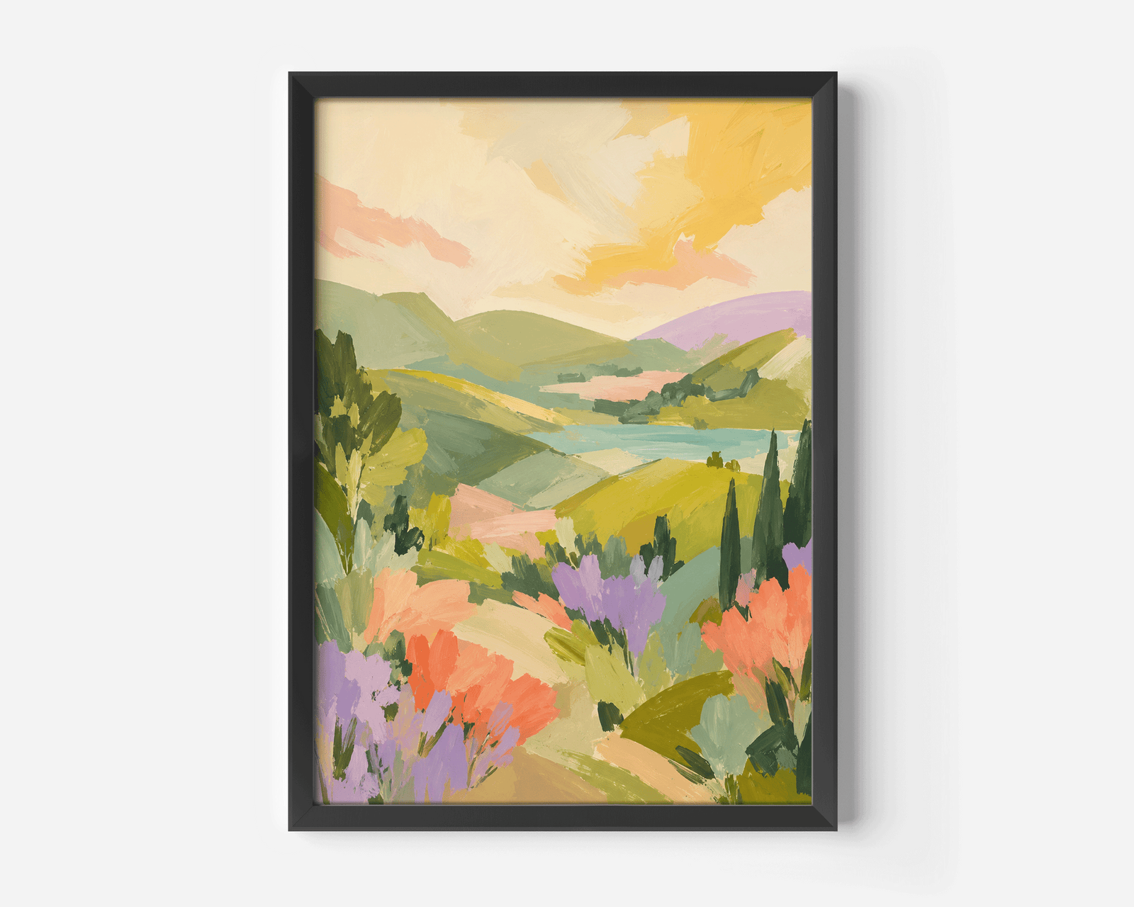 A framed landscape wall art print with a colorful painted scene of rolling green hills, lavender fields, and a yellow sky.