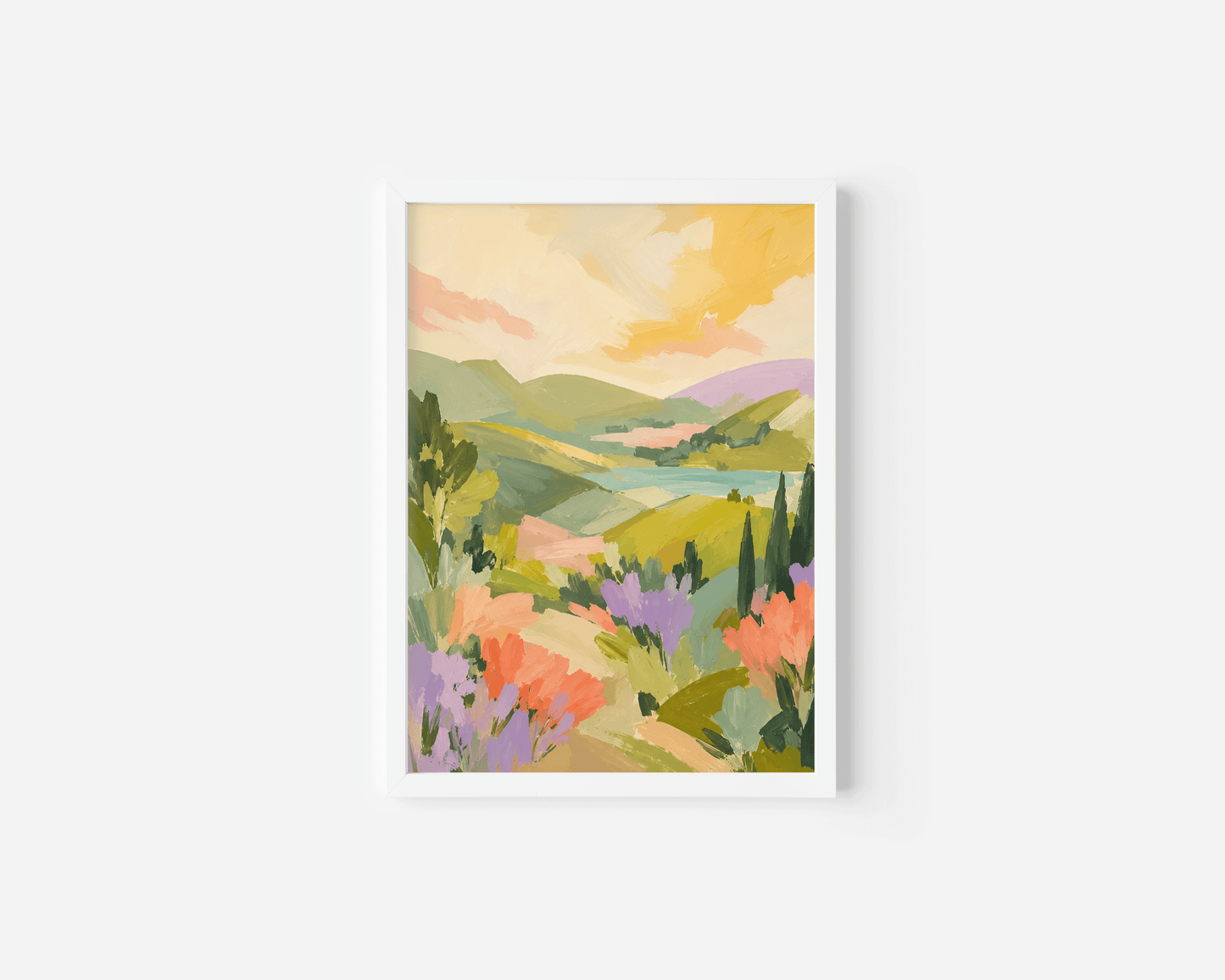 A white-framed landscape art print featuring a colorful painted scene of rolling green hills, lavender fields, and a warm yellow sky.