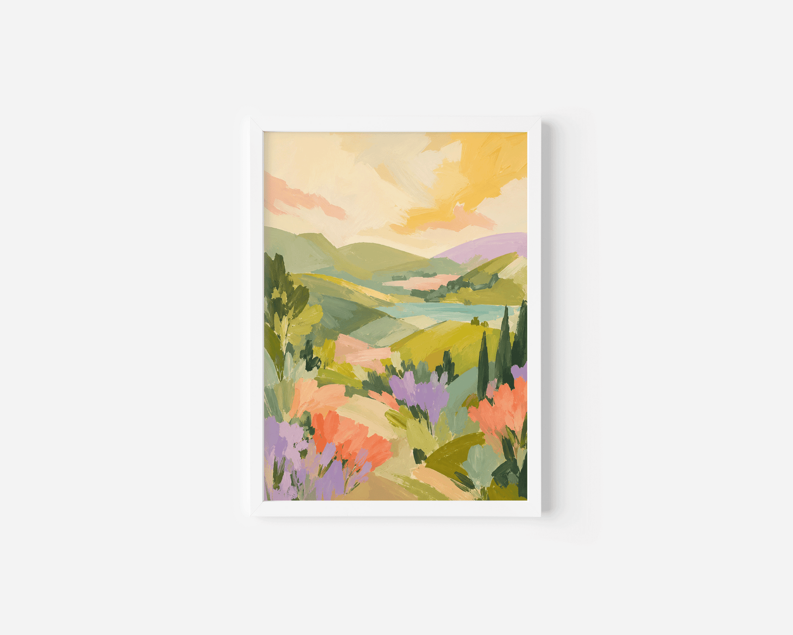 A white-framed landscape art print featuring a colorful painted scene of rolling green hills, lavender fields, and a warm yellow sky.