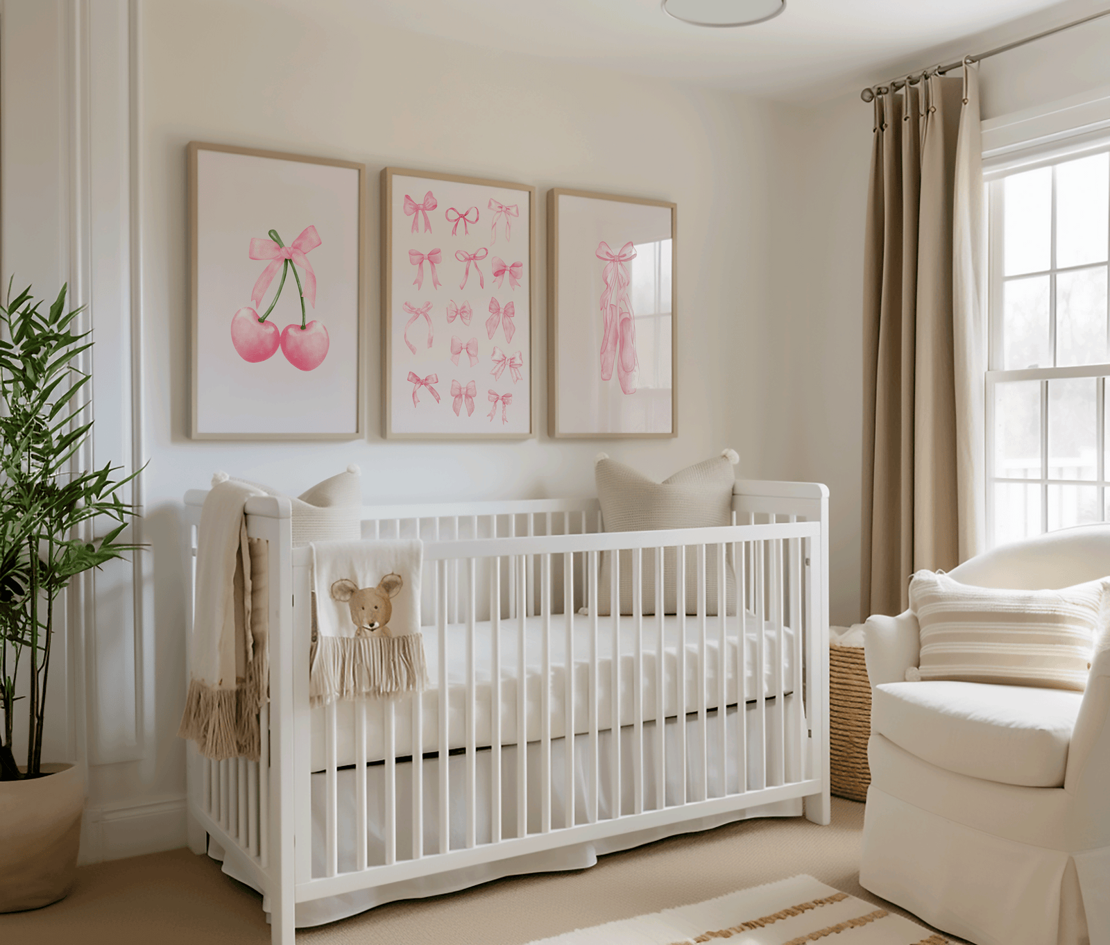 Nursery room with a white crib, teddy bear, and three framed wall art prints of pink bows and cherries