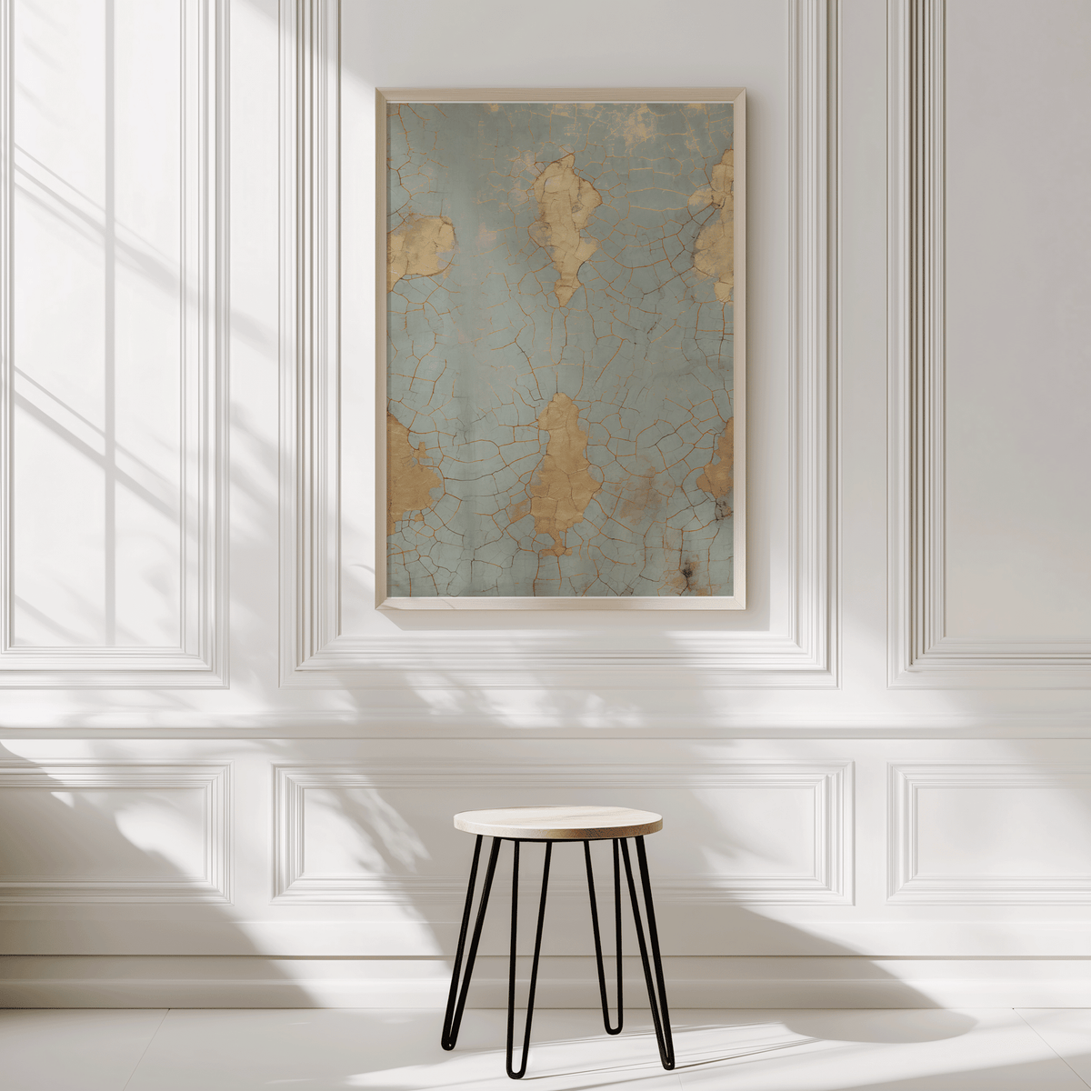 Cracked blue and gold print on a white panelled wall above a small stool