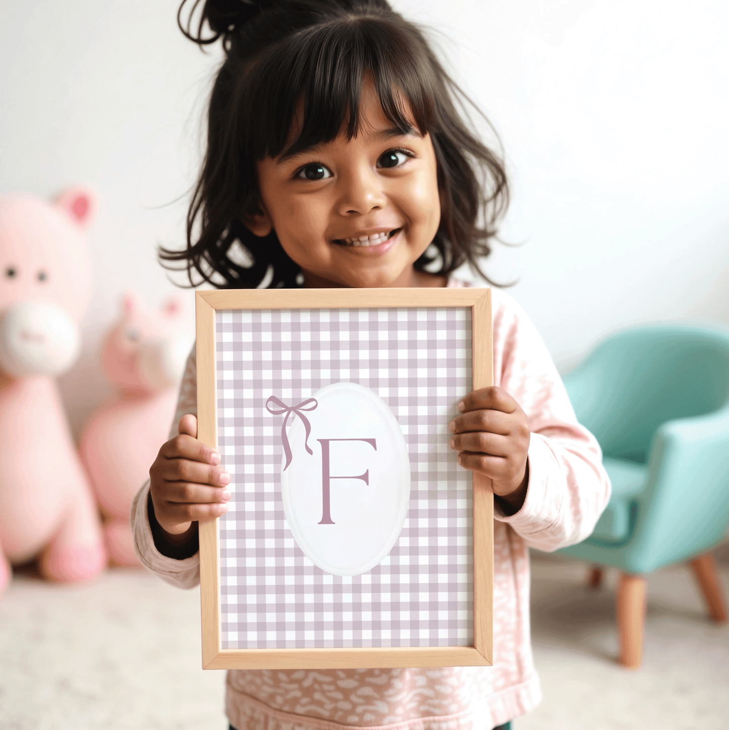Smiling child holding personalized pink gingham monogram letter F wall art framed print baby shower or newborn gift idea