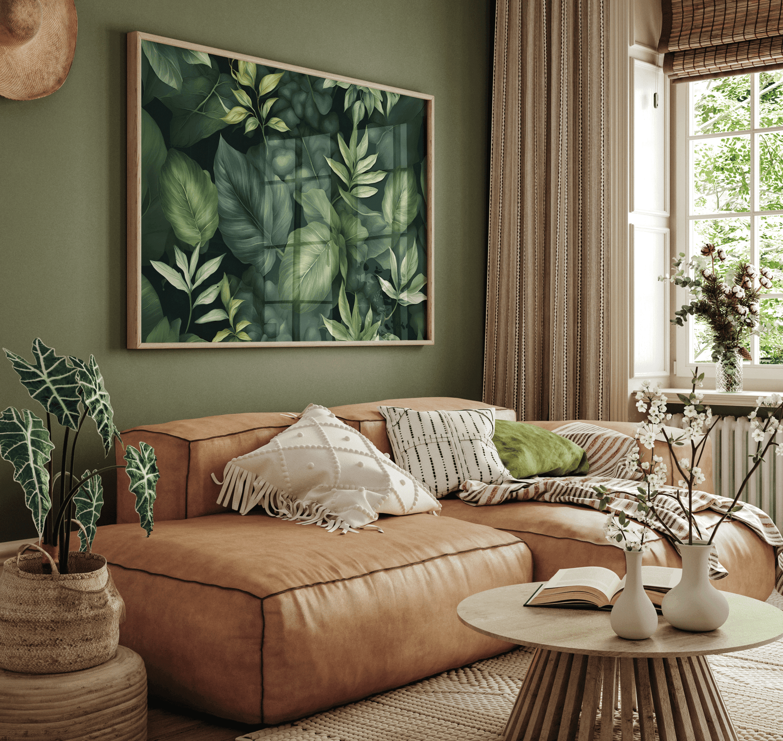 Dark green leaf print above a tan leather sofa in an earthy living room
