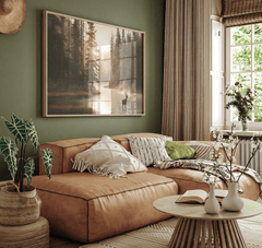 Deer lake forest canvas wall art styled above a tan leather sectional in a cozy living room.