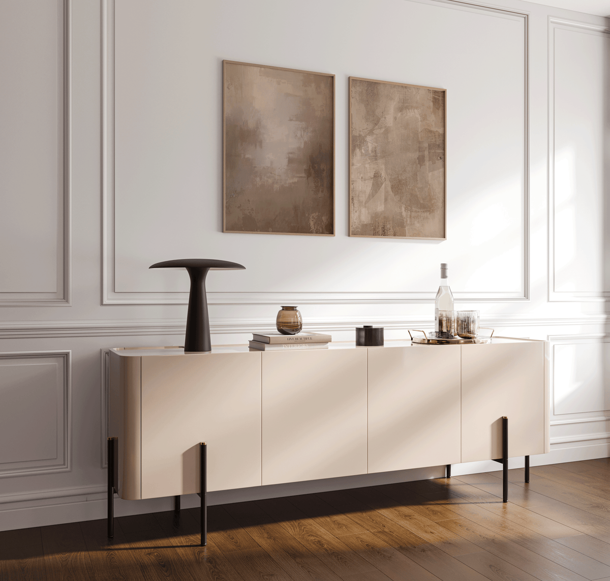 pair of earthy beige and brown abstract prints in wood frames styled above a minimalist console table in a bright entryway with paneled walls