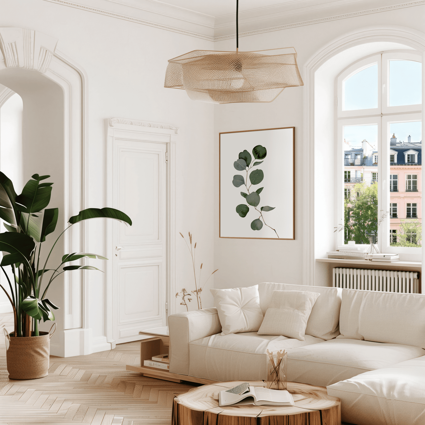 Watercolour eucalyptus print in a gold frame above a cream sofa in a bright living room