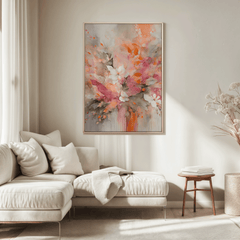 Large floral abstract wall art in pink and orange displayed above a beige sectional sofa