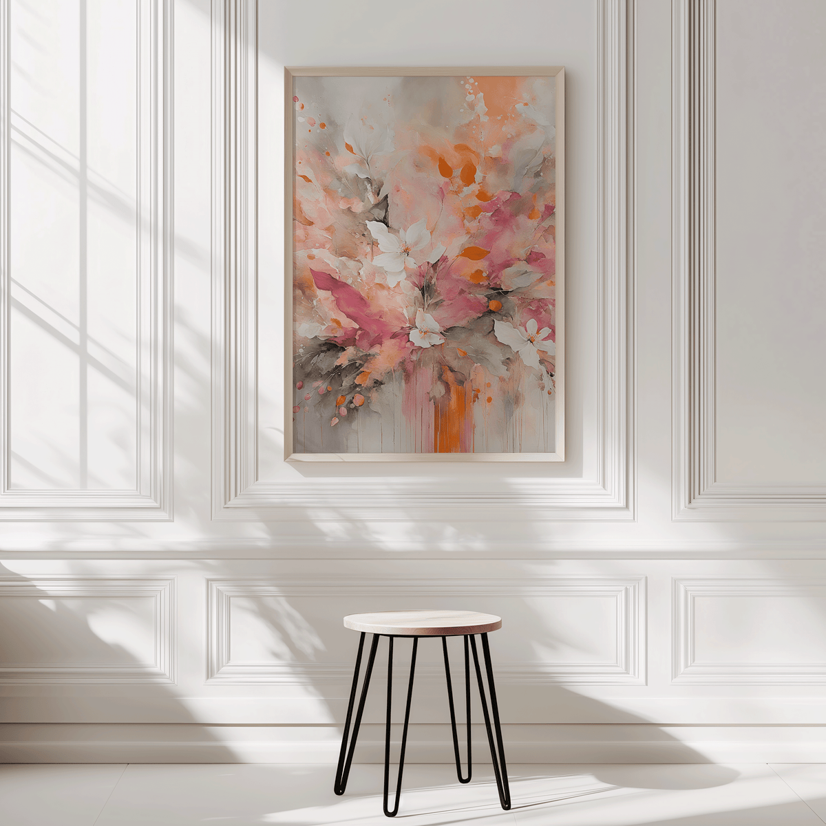 Framed floral abstract wall art in pink and orange tones styled on a white panel wall