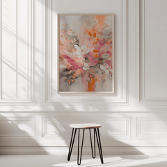 Framed floral abstract wall art in pink and orange tones styled on a white panel wall