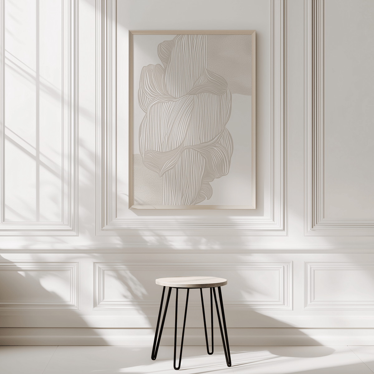Flowing line art print in beige tones with a light wooden frame on a white panelled wall. Abstract linear composition for neutral, minimal interior, made-to-order and ready to hang wall art print.