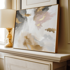 Framed modern abstract artwork with blush pink, gold foil accents, light and dark grey, white and beige colors on a fireplace in a living room.