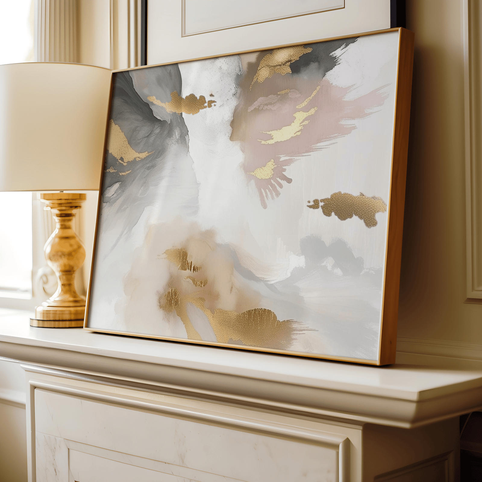 Framed modern abstract artwork with blush pink, gold foil accents, light and dark grey, white and beige colors on a fireplace in a living room.