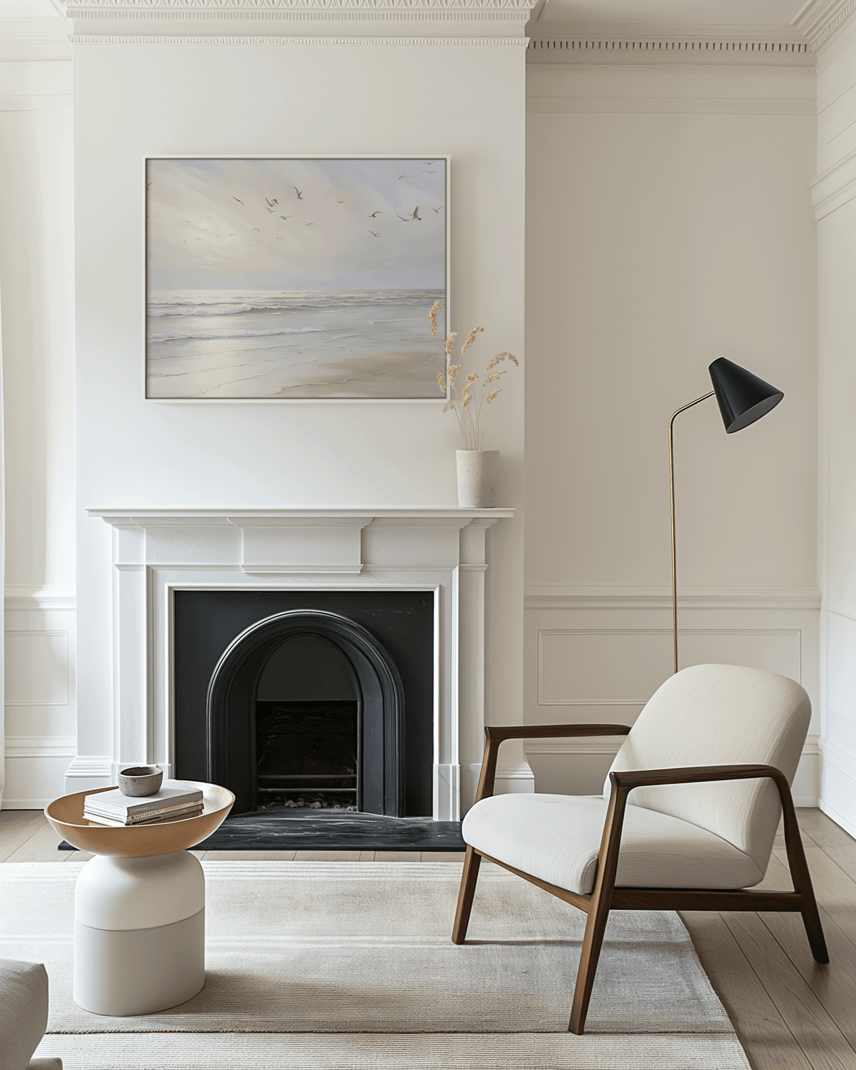 Framed beach ocean print with gentle waves and flying seagulls displayed above white fireplace — elegant neutral wall art for living room decor