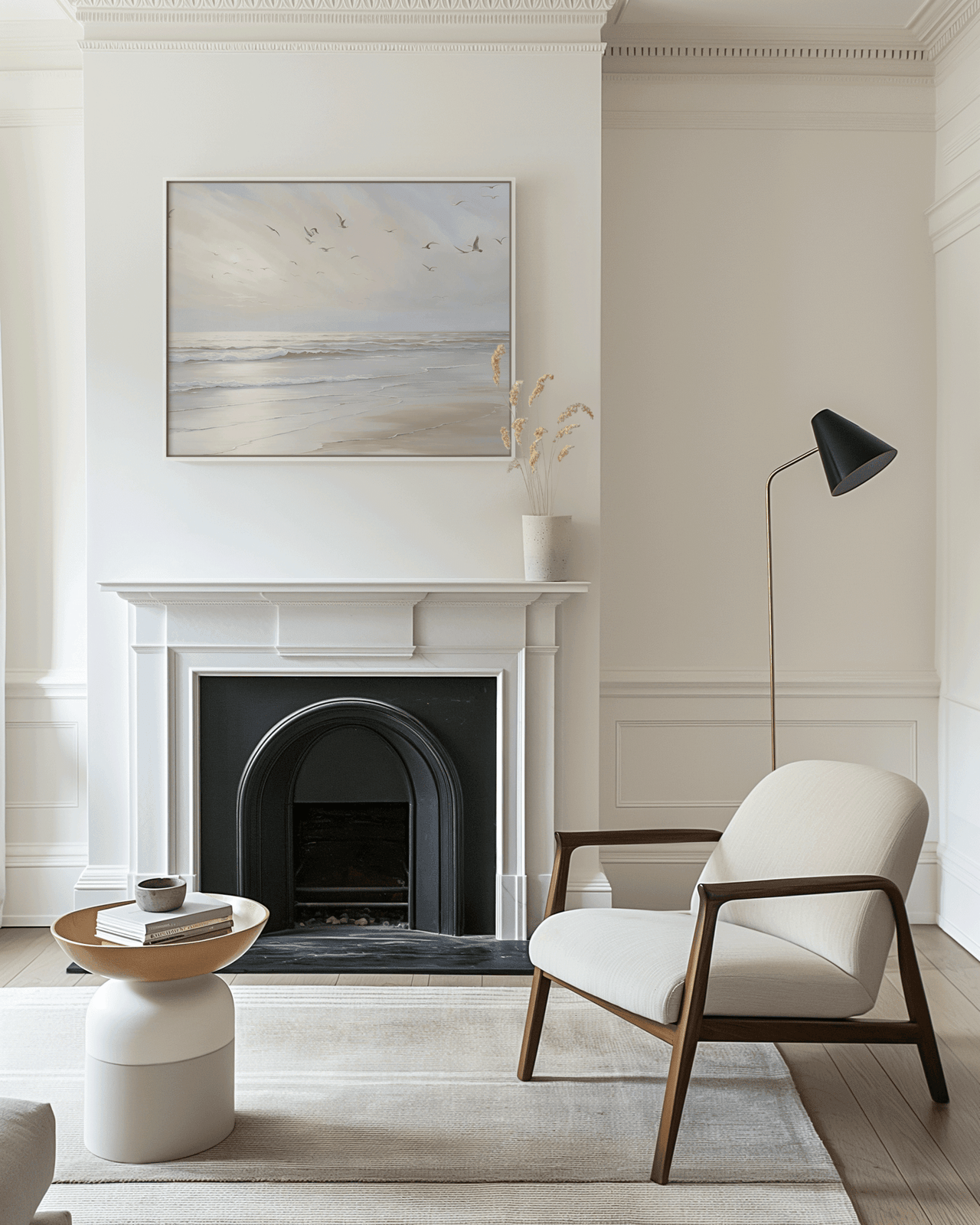 Framed beach ocean print with gentle waves and flying seagulls displayed above white fireplace — elegant neutral wall art for living room decor