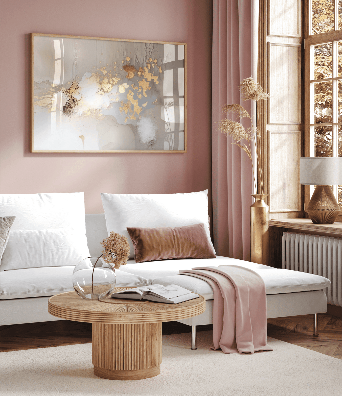 Framed fine art paper print of a modern abstract wall art with beige, grey, and gold metallic brushwork above a white sectional sofa in a living room with blush pink walls and velvet curtains.