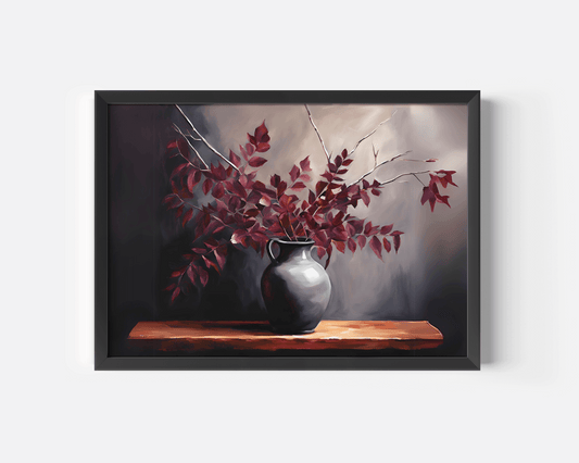 Close-up of a black framed artwork of a vase with red leaves on a wooden shelf against a dark background