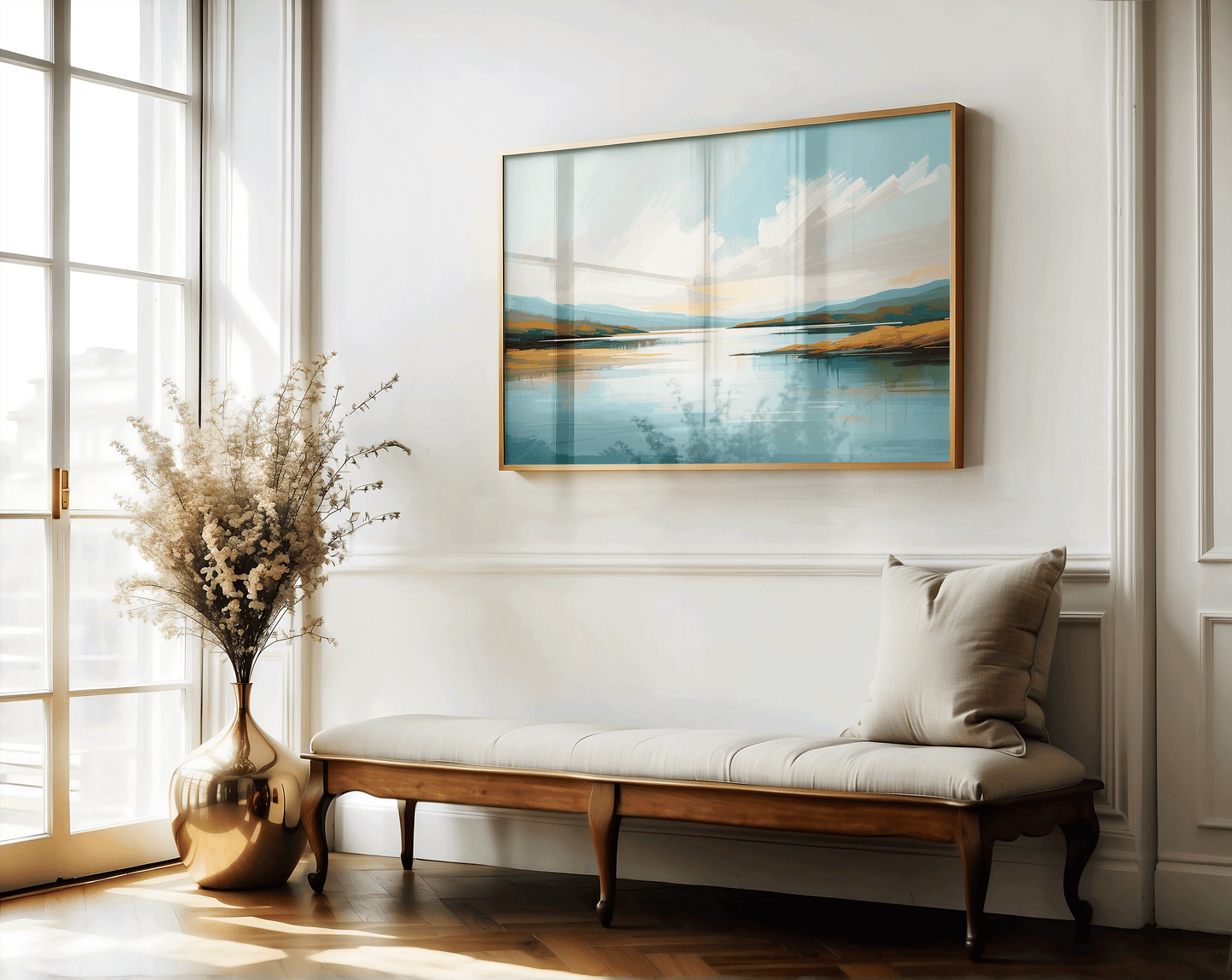 Framed coastal landscape wall art with soft blue tones in elegant entryway above a bench