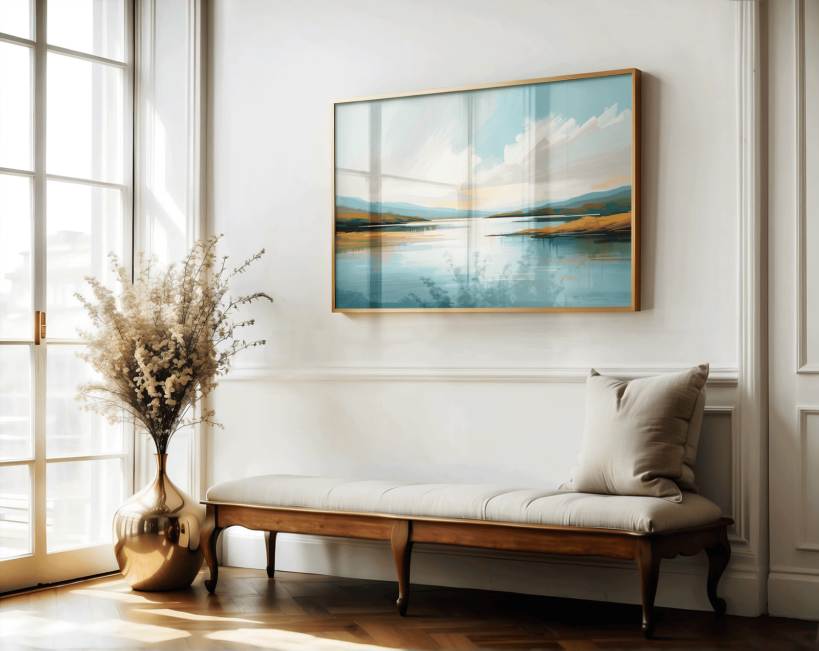Framed coastal landscape wall art with soft blue tones in elegant entryway above a bench