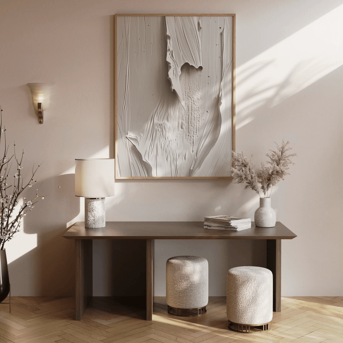 Modern entryway hallway interior with a brown wooden console table, beige and white abstract artwork framed, and decorative items.