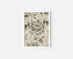 Close-up of an elegant green floral wall art print with white frame and beige background on a white wall.