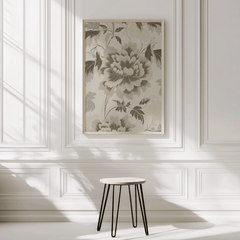 Neutral green beige floral botanical wall art framed hanging above table in bright sunlit room with white walls