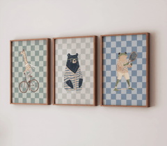 Set of 3 vintage, safari-themed animal prints including giraffe, bear, and frog on a white wall