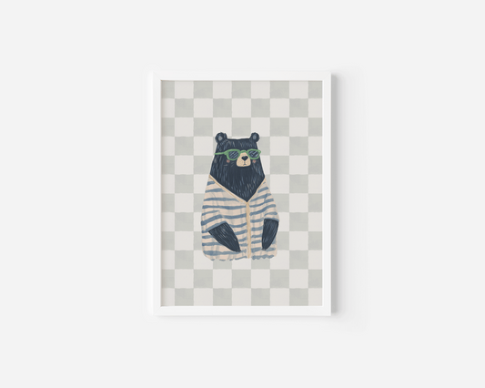 Funky bear nursery wall art print featuring a bear in sunglasses and striped sweater on a checkered background. Available as framed fine art paper or canvas, perfect for boys’ nursery, bedroom, or playroom decor.