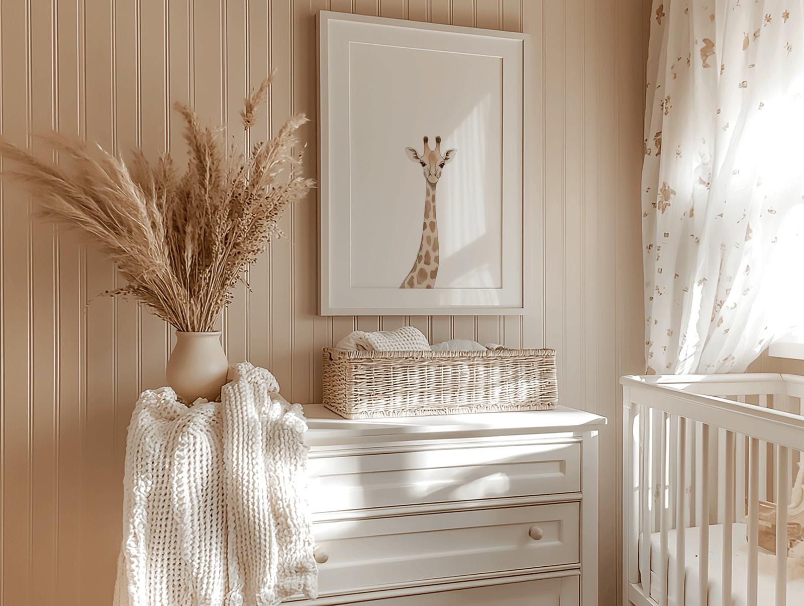 Giraffe nursery wall decor framed above a white dresser with rustic pampas grass in a beige vase and a white crib under a window with sunlight shining through