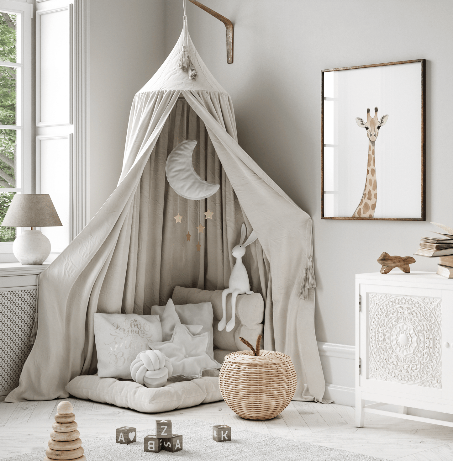 Woodland animal giraffe wall art framed in kids' playroom with a canopy and plush toys and basket on the floor