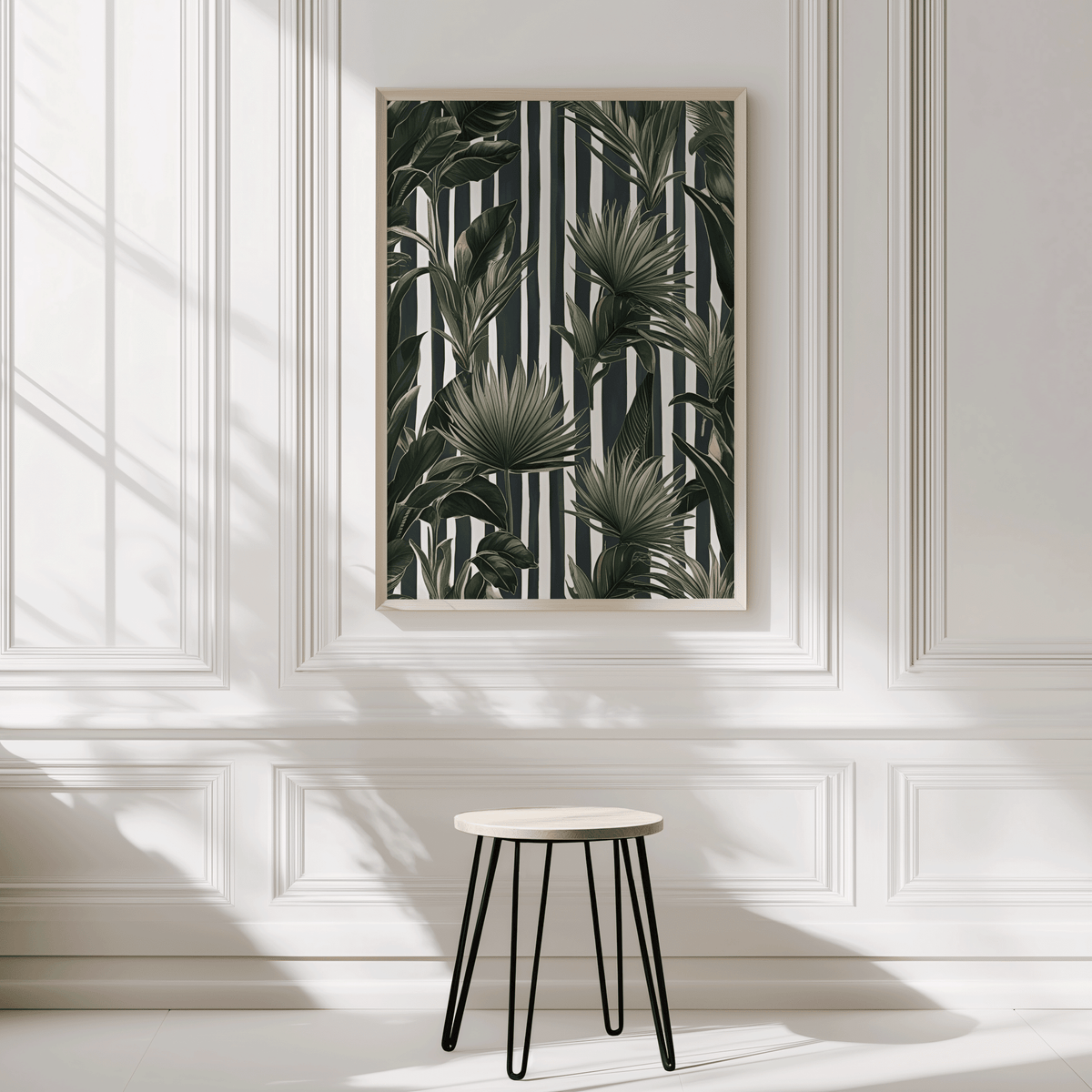 Green tropical leaves wall art on black and white stripes in a natural wood frame on a panelled entryway wall