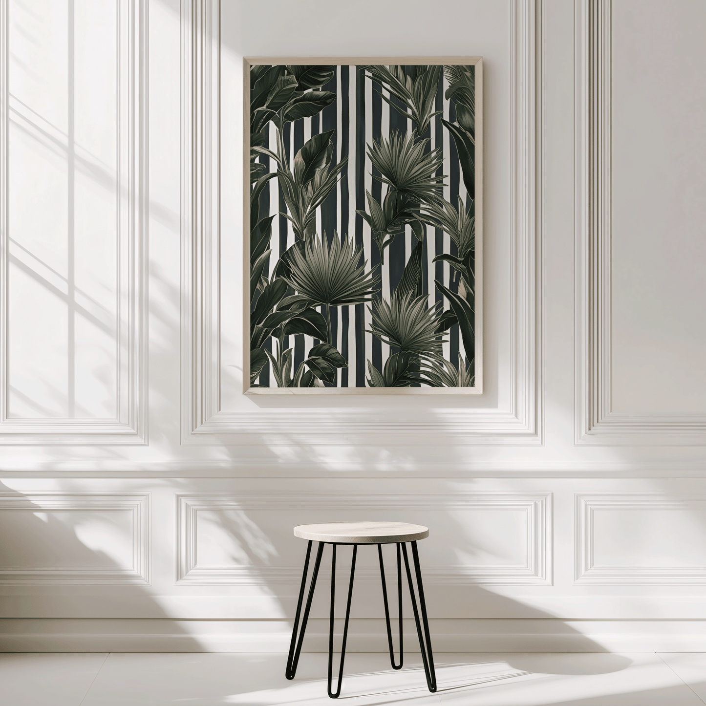 Green tropical leaves wall art on black and white stripes in a natural wood frame on a panelled entryway wall