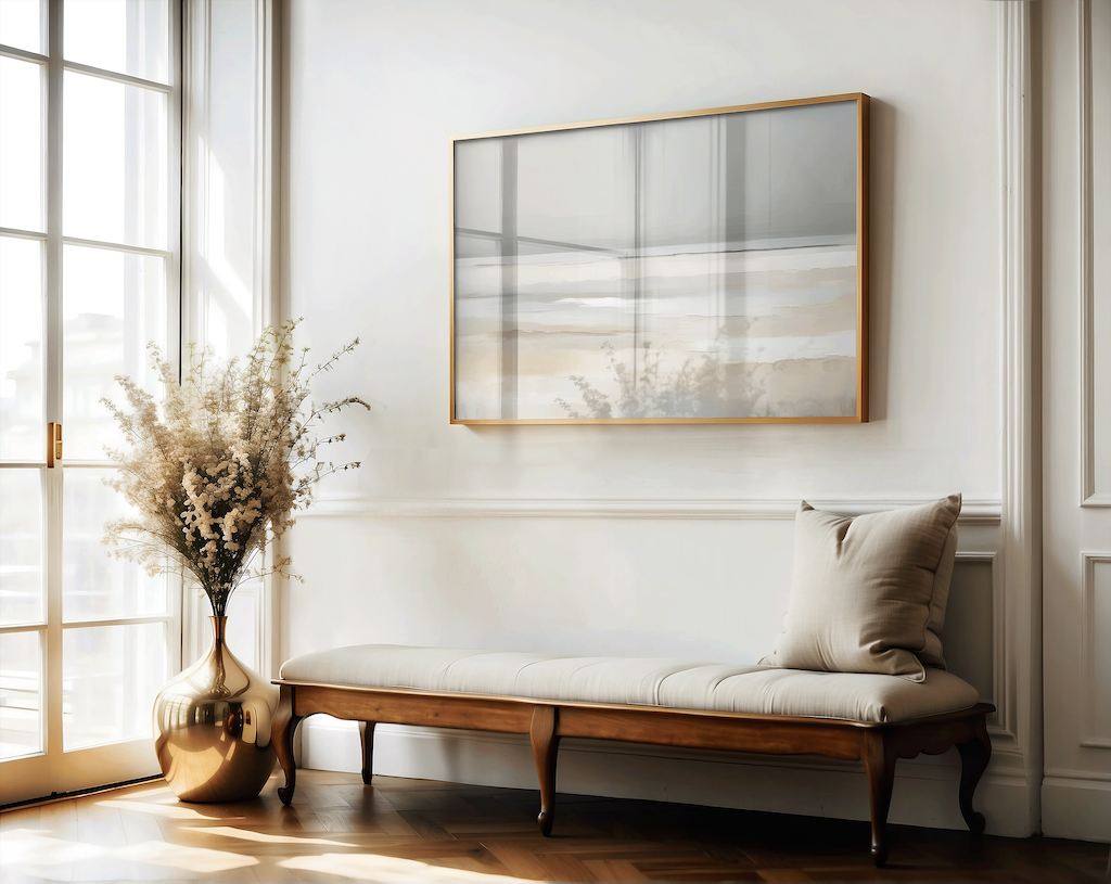 Nestled corner of a hallway with a wooden bench, decorative pillow, vase with dried plants, and framed abstract beach canvas wall art.
