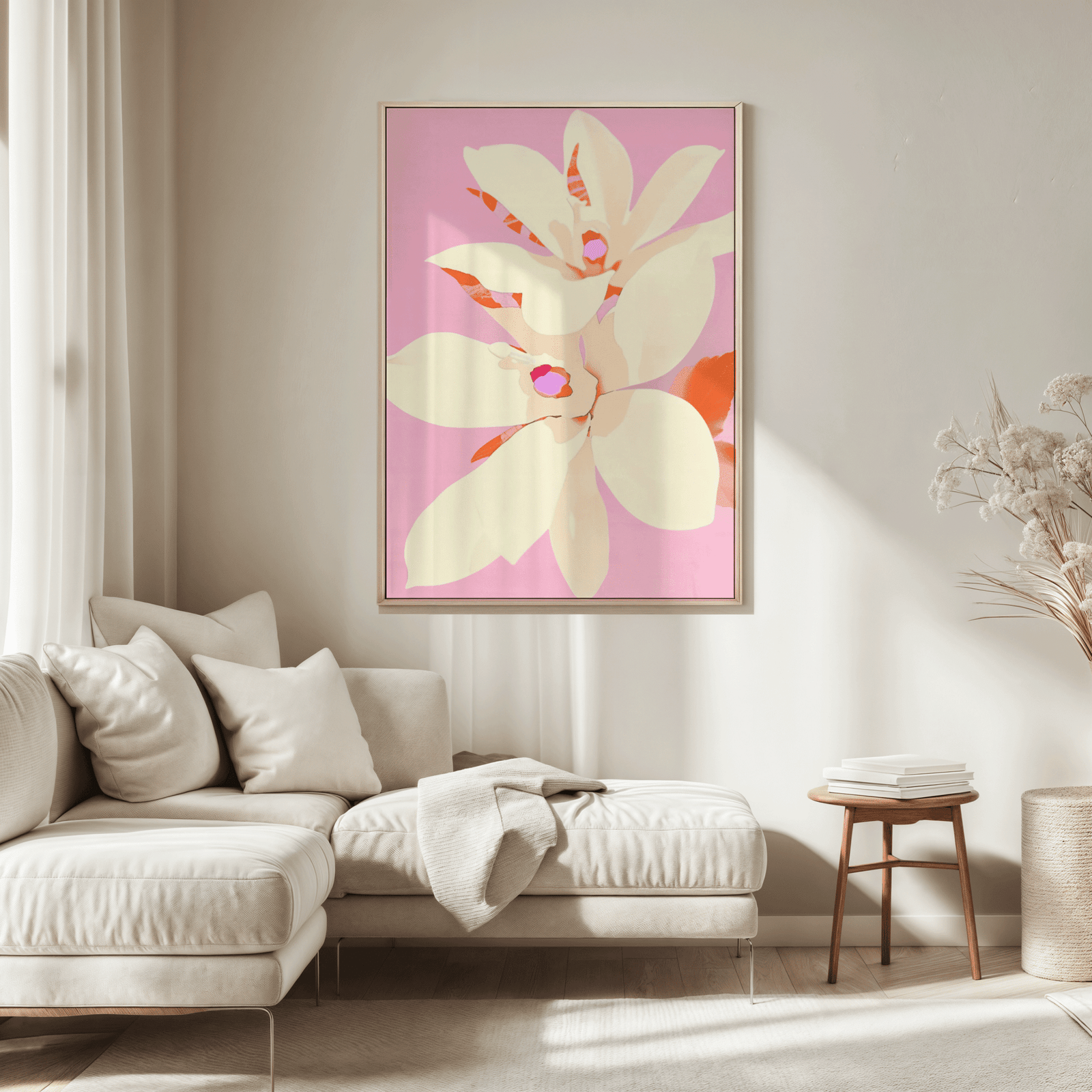 A floral wall art illustration on a blush pink background featuring coral leaves and pale yellow blooms. Framed in a light wood and hung on a beige wall in a neutral, modern living room above a cream sectional sofa.
