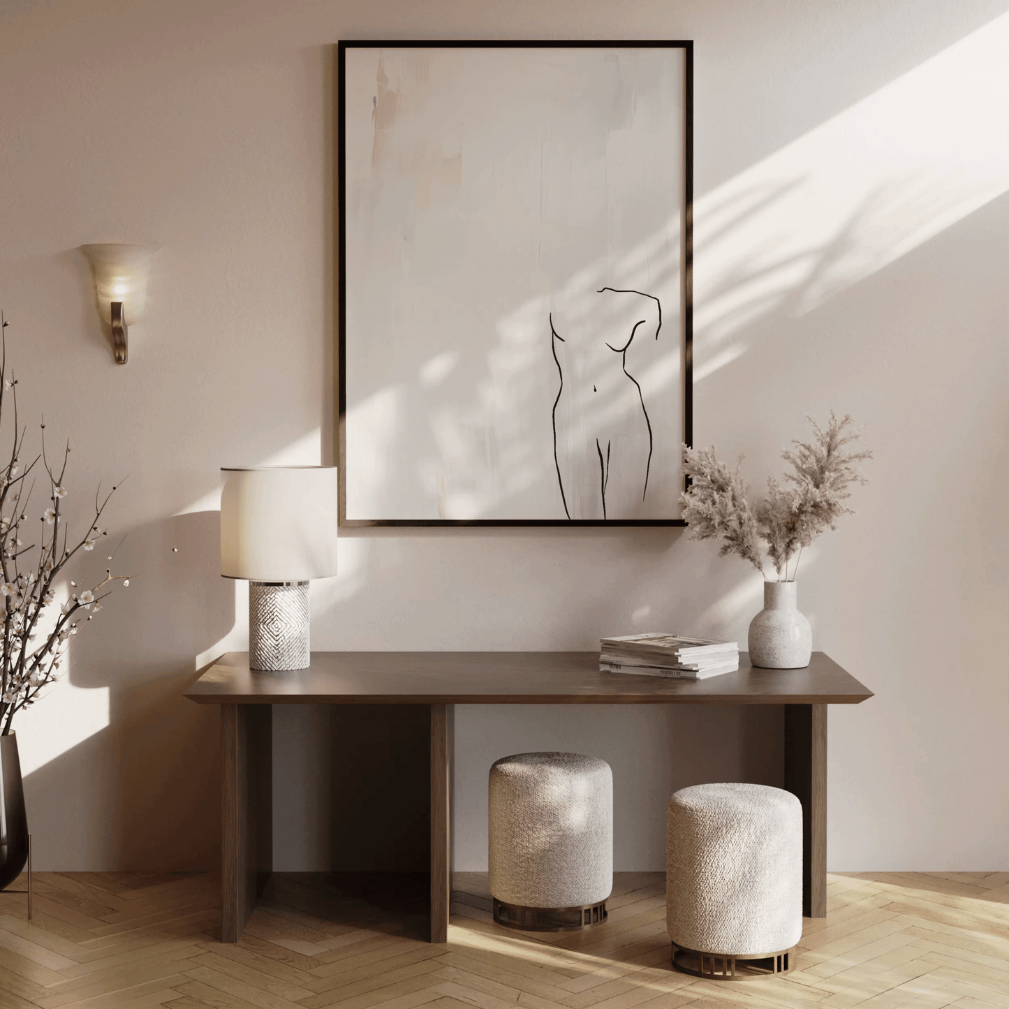Oversized minimalist figure wall art framed in wood above a console table in an entryway or hallway with ceramic vase, dried florals, and soft morning sunlight casting shadows on neutral walls