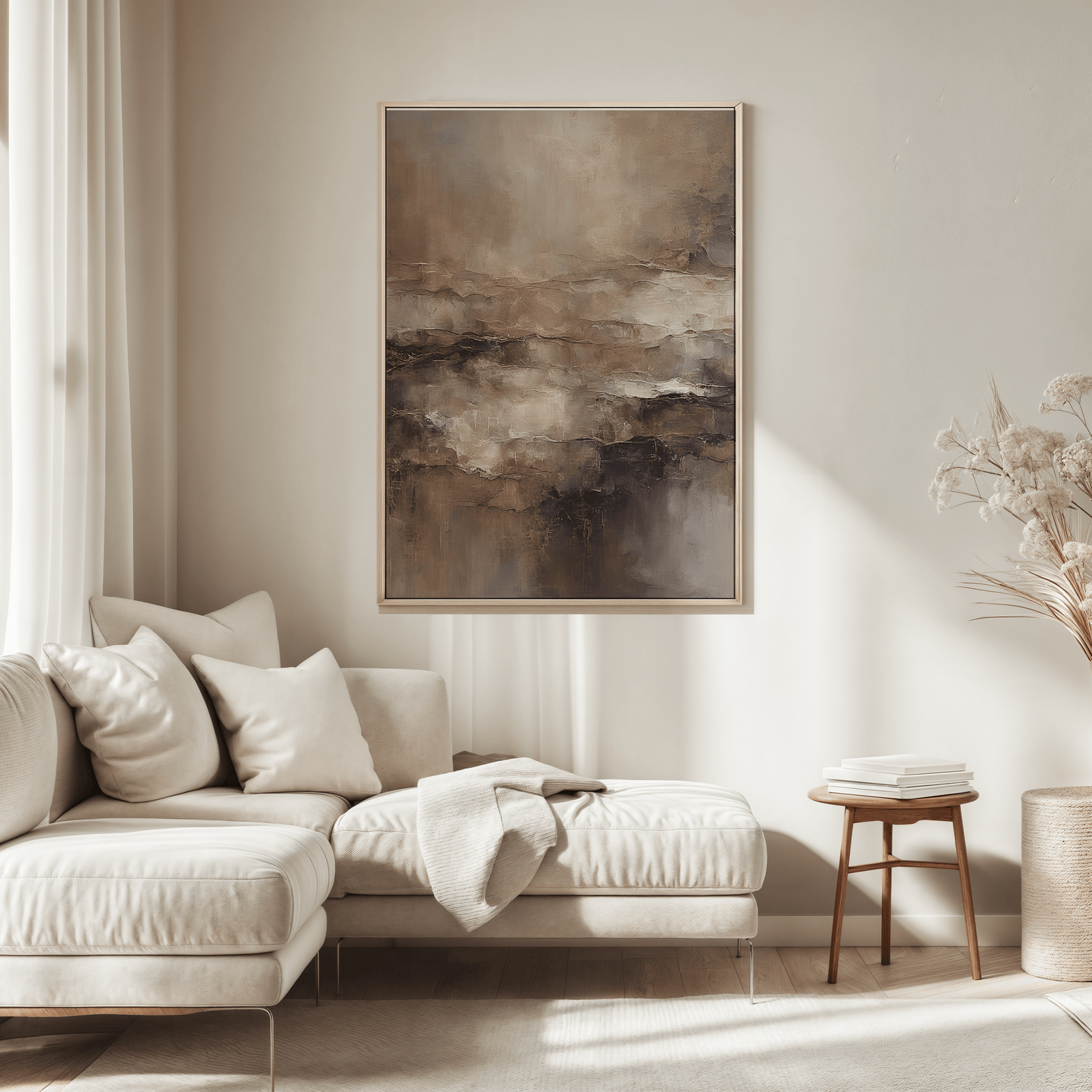 Large moody abstract wall art print in beige and brown tones above a sectional sofa in a minimal living room