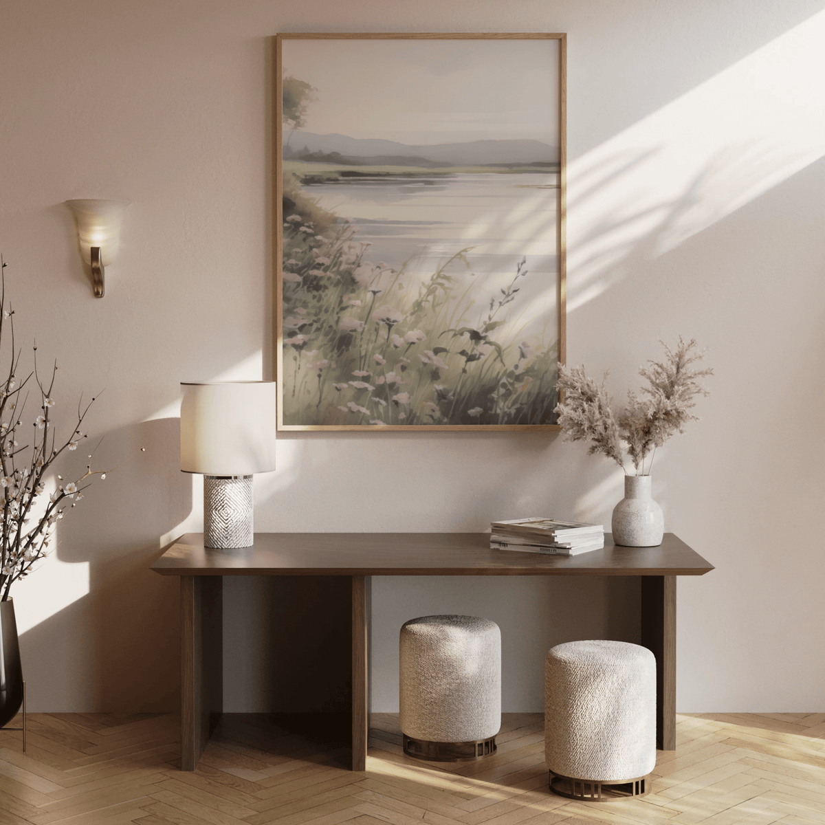 Large neutral landscape wall art above a wooden console table in an entryway