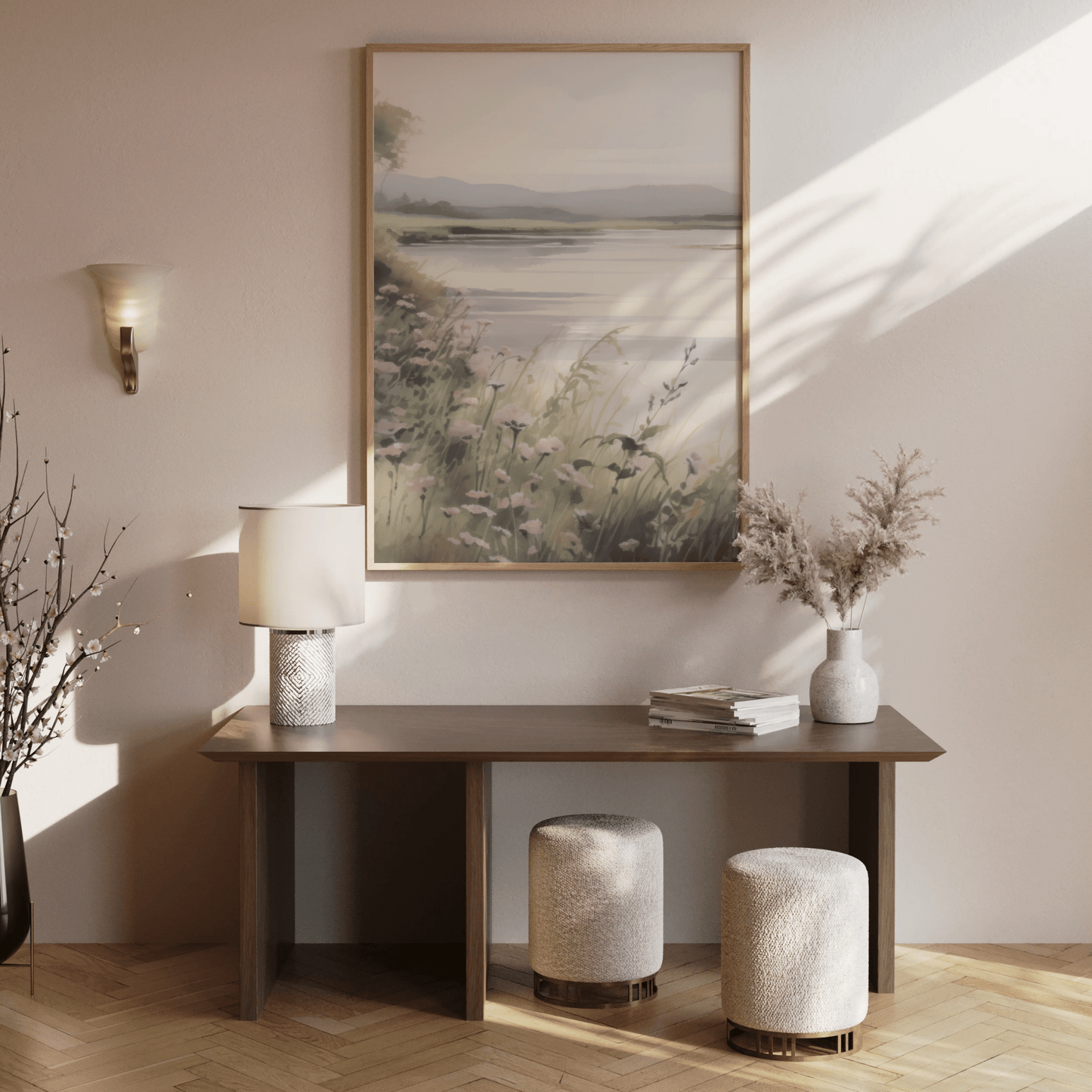 Large neutral landscape canvas wall art above wooden console table with decor accents in entryway